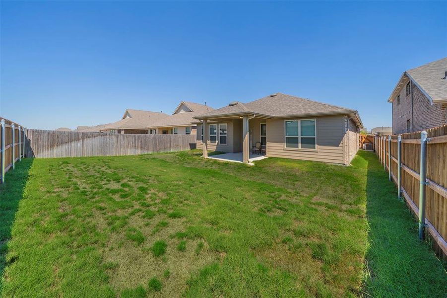 Back of property with a patio area and a yard