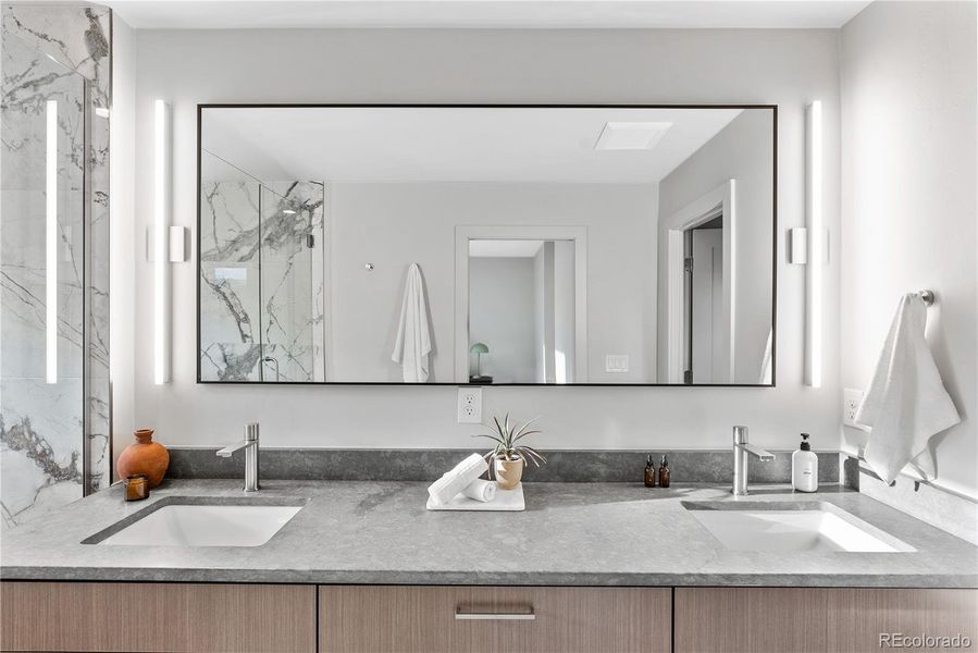 Dual sinks and abundant cabinetry round out the primary bathroom.