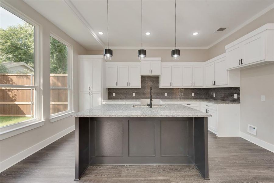 Kitchen featuring hanging light fixtures, sink, and dark hardwood / wood-style flooring