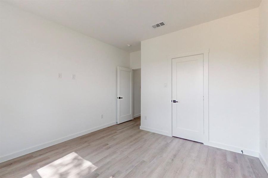 Unfurnished bedroom with light wood-type flooring