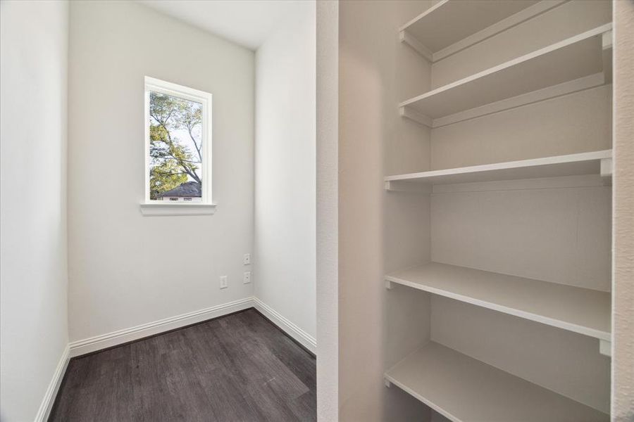 This spacious first-floor bedroom offers ample natural light through multiple windows, creating a bright and welcoming atmosphere. The neutral carpeting and clean design provide a versatile space suitable for a guest room, home office, or personal retreat. With a functional layout, this room offers comfort and flexibility for a variety of uses.