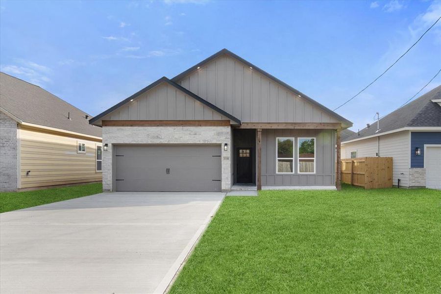 Look at this beauty! 11180 Fieldcrest Drive blends a sleek white-and-gray stone exterior with warm cedar accents, board-and-batten Hardie plank, and welcoming soffit lights—serving up serious curb appeal.