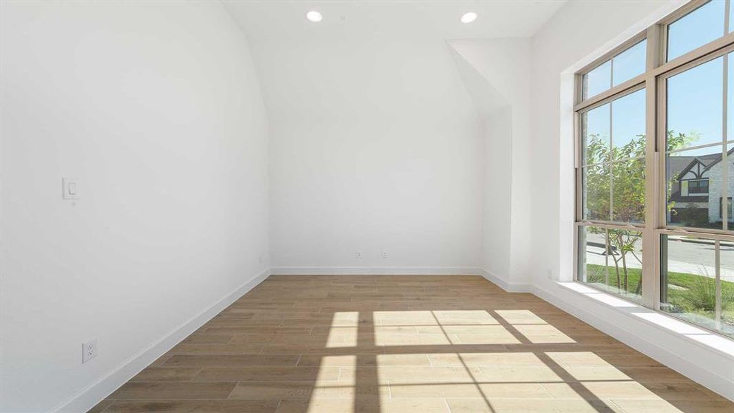 Empty room featuring light hardwood / wood-style floors and a wealth of natural light