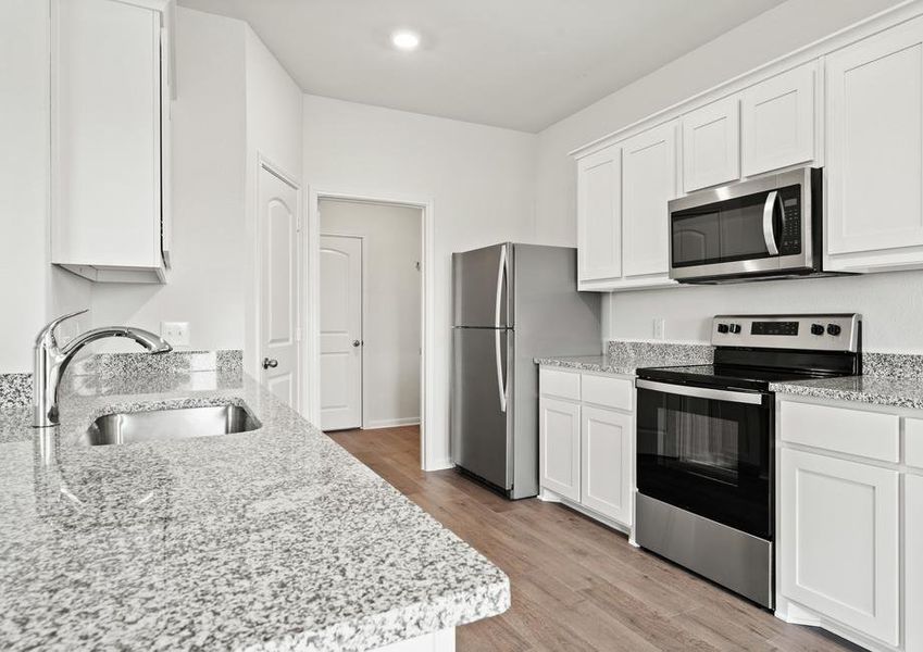 The kitchen of the Cypress has sprawling granite countertops.