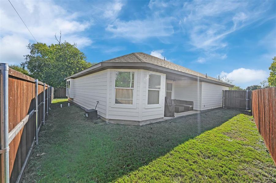 View of property exterior with a lawn