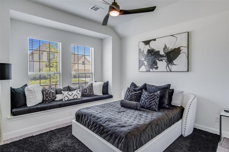 Bedroom featuring ceiling fan and dark carpet