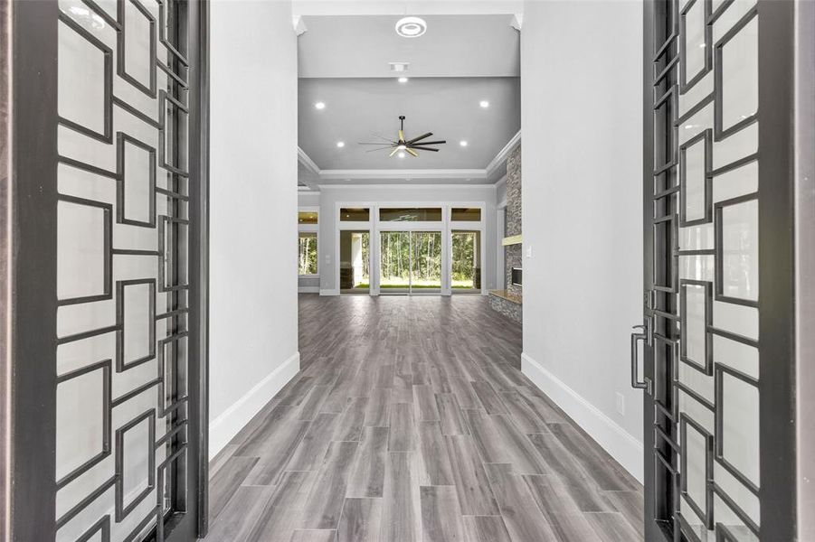 Enter through the 369 sf covered front porch through dramatic 6' x 8' double insulated Forged Iron Doors into the light & bright Foyer with 16' ceilings.