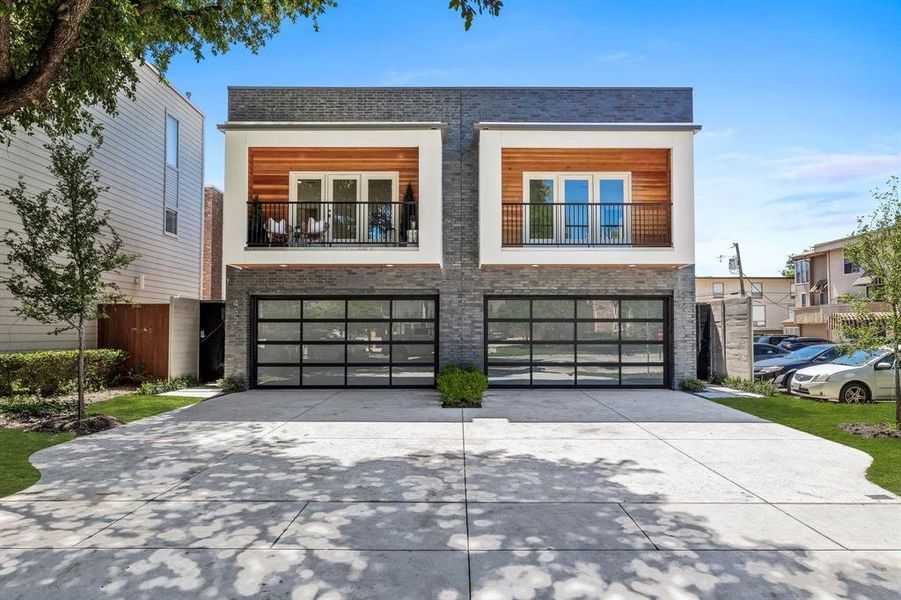 View of front of property with a balcony and a garage