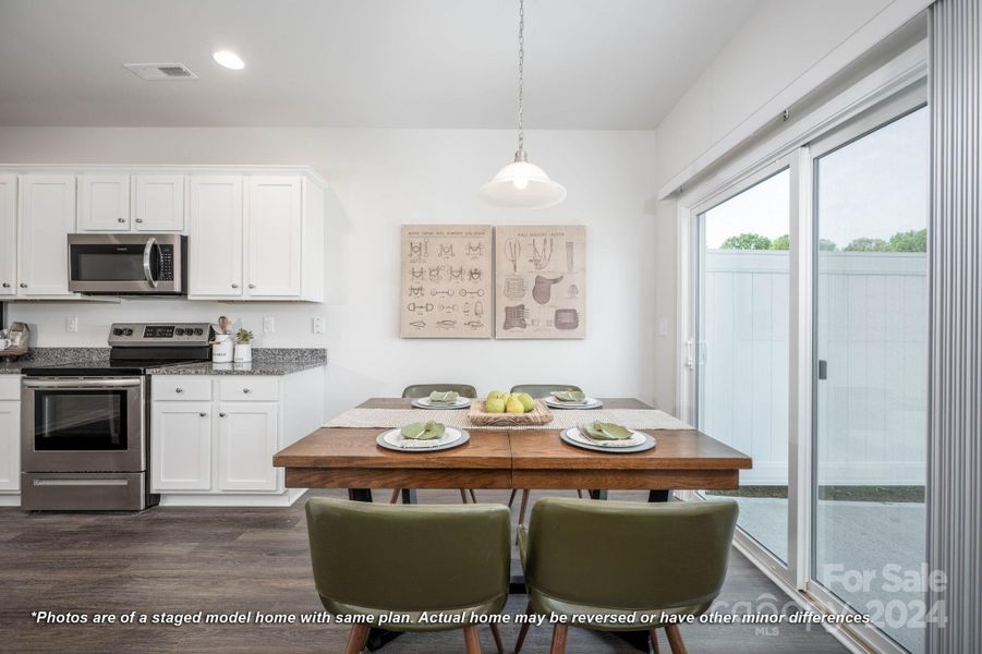 Dining area & kitchen with access to back patio