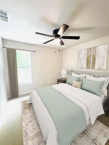 Bedroom with ceiling fan and light colored carpet