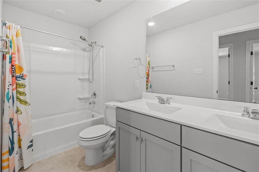 Shared bathroom upstairs with dual vanity.