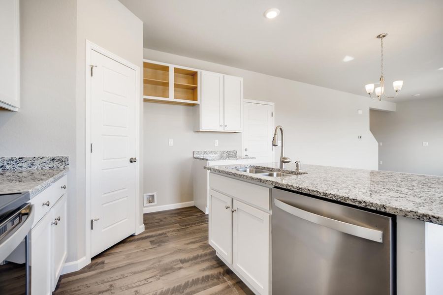 Kitchen island and great room of the Fraser floor plan by Century Communities