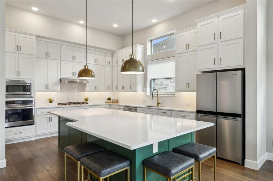 Kitchen with a kitchen island, a kitchen bar, dark wood-type flooring, stainless steel appliances, and sink