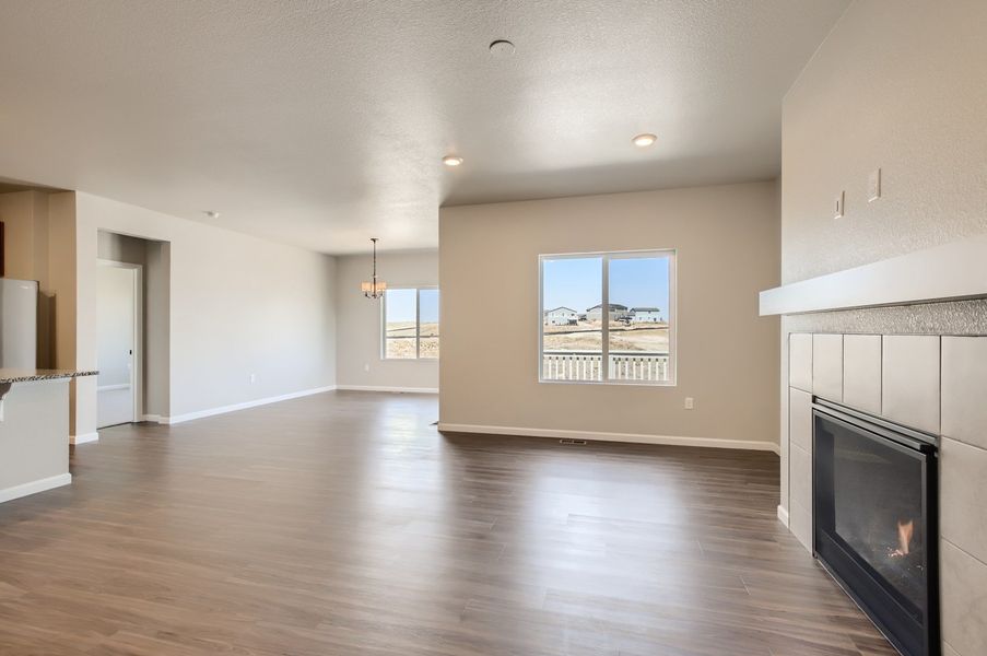 Great room and breakfast nook and fireplace of the ranch style Telluride plan by Century Communities