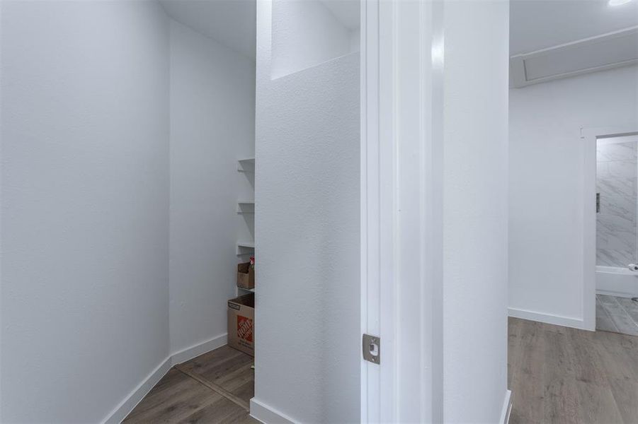 Corridor with light hardwood / wood-style flooring