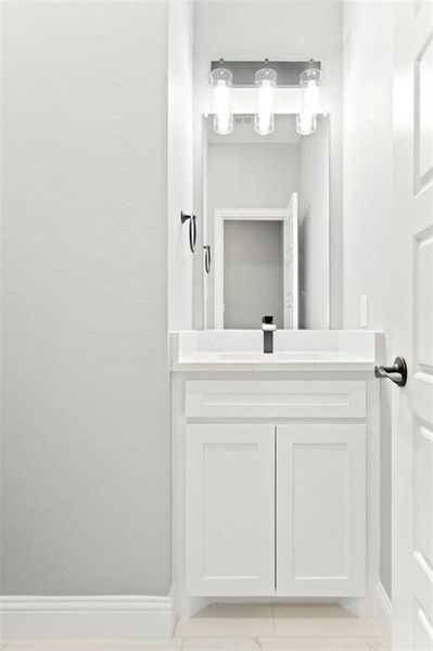 Bathroom featuring tile patterned flooring and vanity