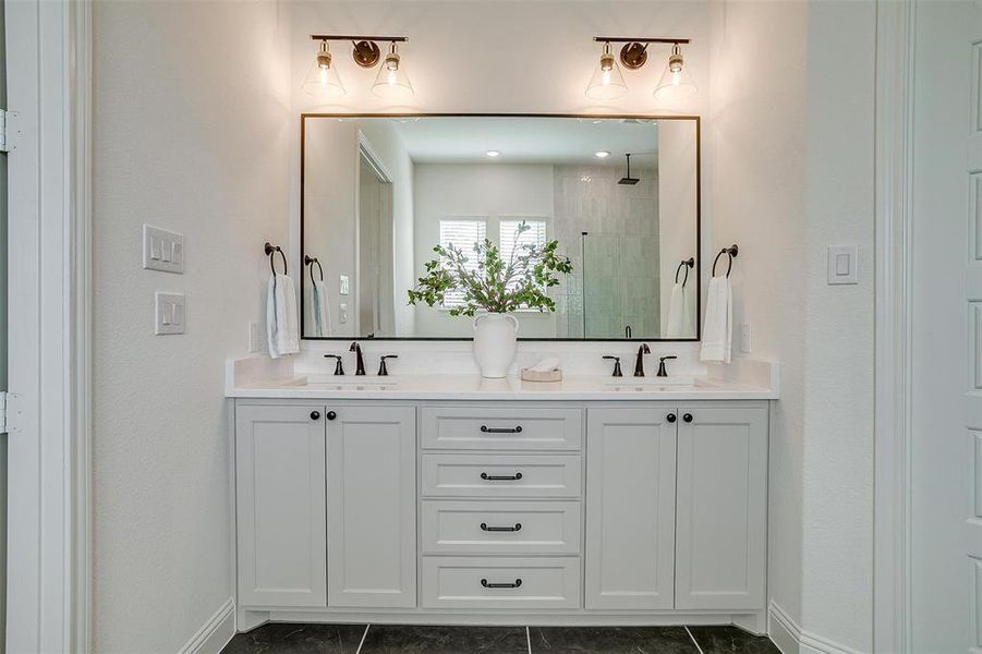 Bathroom with vanity, tile patterned floors, and walk in shower