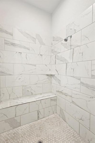 Bathroom featuring a tile shower