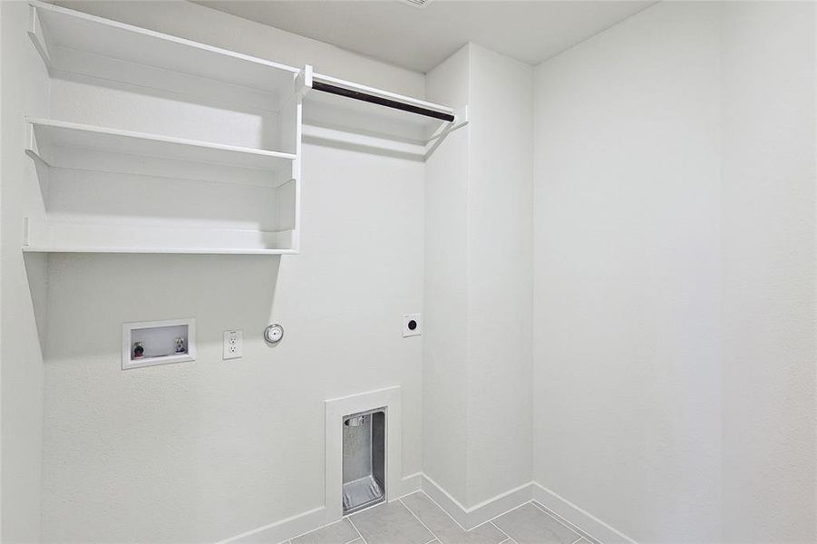 Washroom featuring washer hookup, gas dryer hookup, light tile patterned floors, and electric dryer hookup