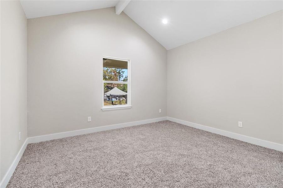 Master bedroom with cathedral ceilings.