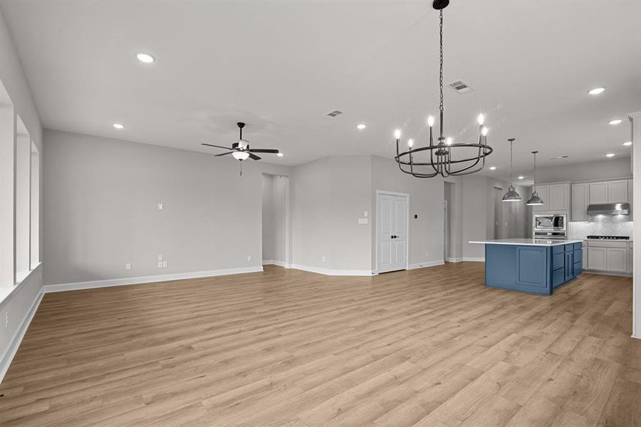 EXAMPLE PHOTO: Large Living area with high ceilings, surround sound pre-wire & low maintenance vinyl plank floors.  Easy to entertain with this open design.