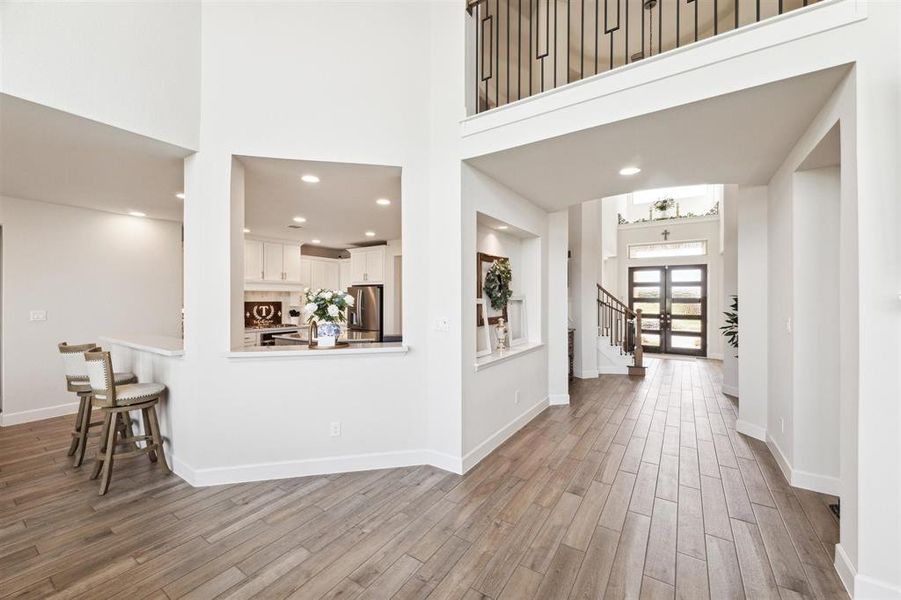 This view shows the lighted, recessed art niche in the hallway and lower level tile floors.