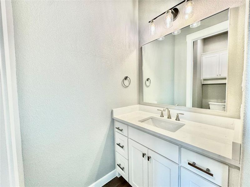 Bathroom featuring vanity, toilet, and hardwood / wood-style floors