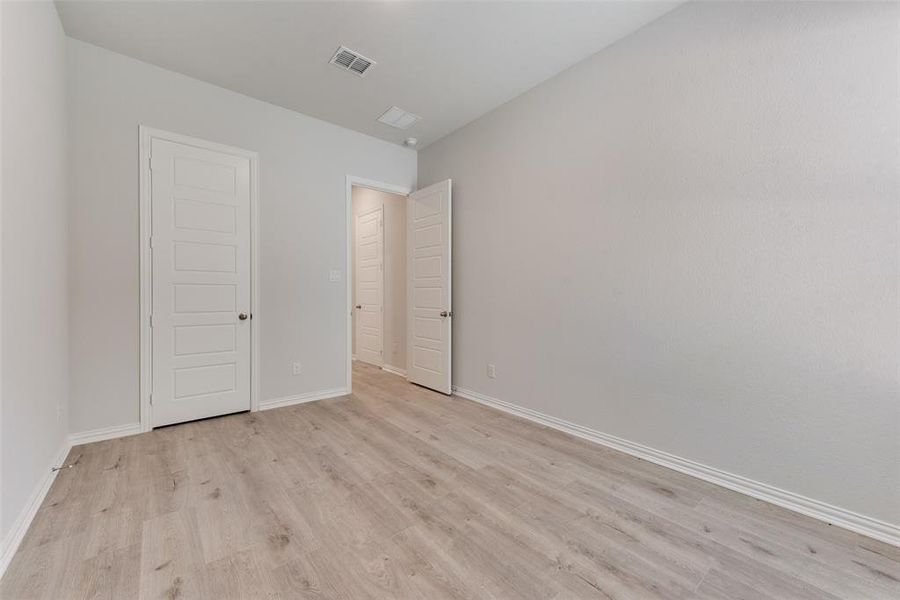 Unfurnished bedroom featuring light hardwood / wood-style flooring