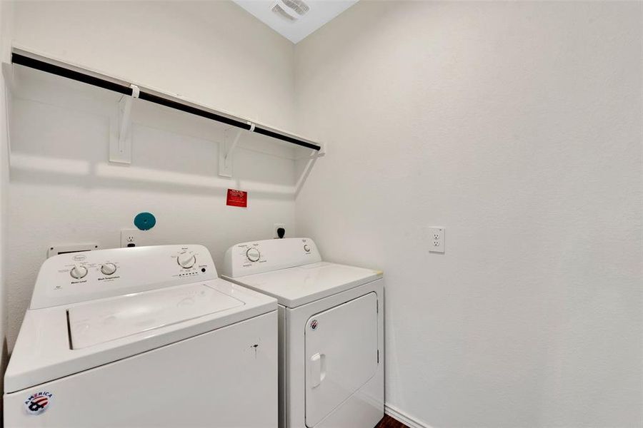 The utility room is equipped with a washer and dryer. The home is also equipped with a tankless water heater.