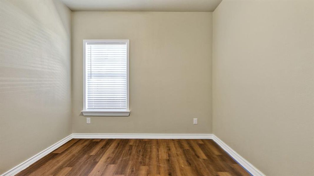 Empty room with dark wood-type flooring