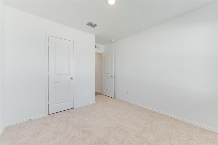 Unfurnished bedroom featuring light carpet