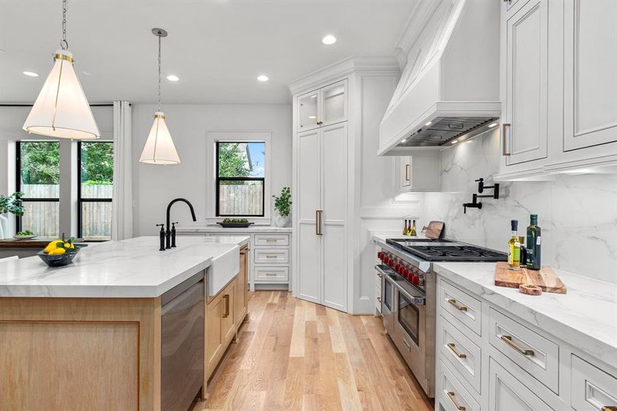 Quartz counters & backsplash elevate this Chef's Kitchen. Custom site built cabinets & Designer selected fixtures/hardware.