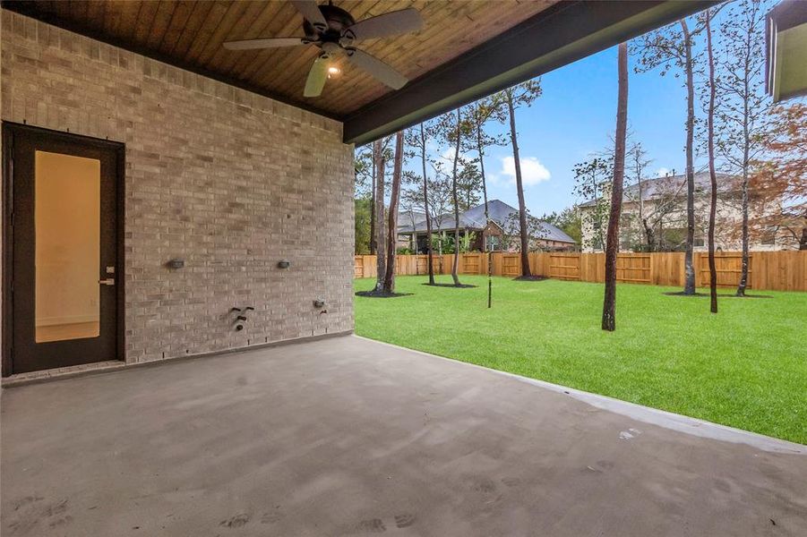 Covered Rear Patio with Ceiling Detail, Fan, Gas Connection, Water Connection, and Electric Outlets.