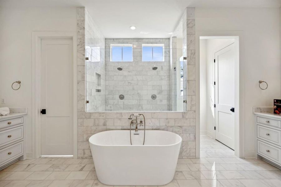 Oversized walk-in shower features dual shower heads. Separate water closet and separate linen closet.