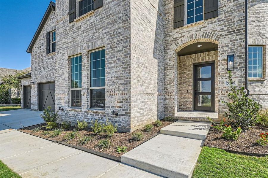 Doorway to property with a garage