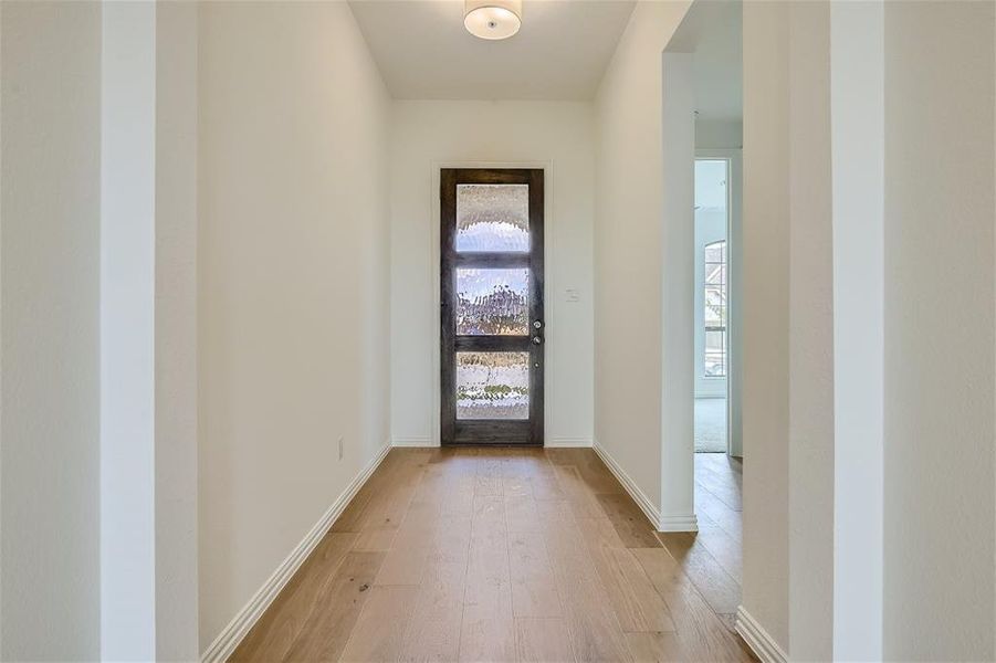 Entrance foyer with wood-type flooring