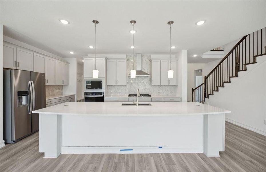 Spacious kitchen with large island *real home pictured