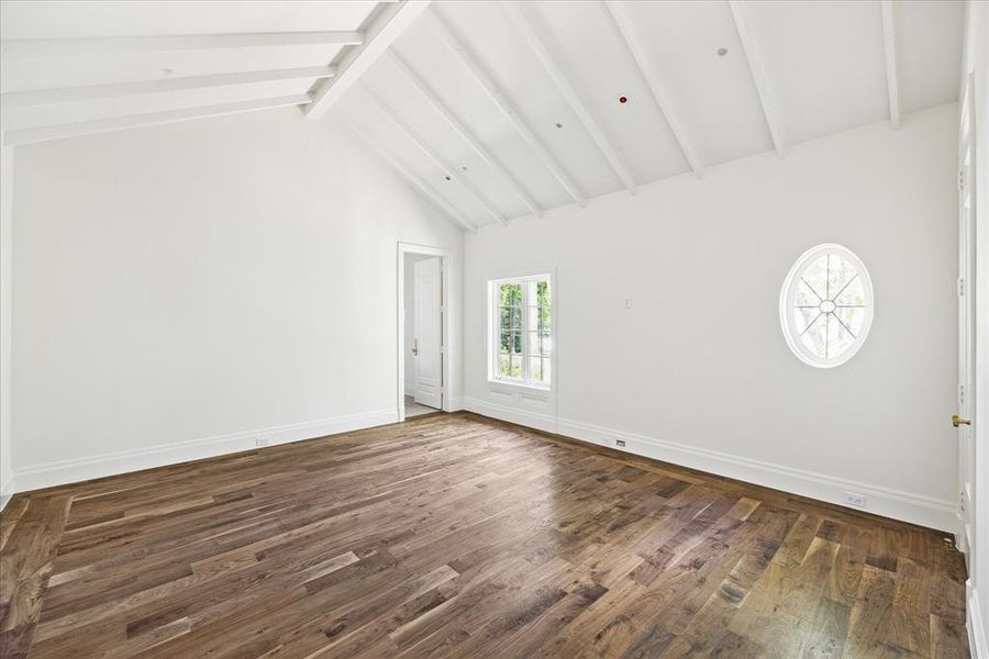 This secondary bedroom features vaulted ceilings with an en-suite bathroom and walk-in closet.