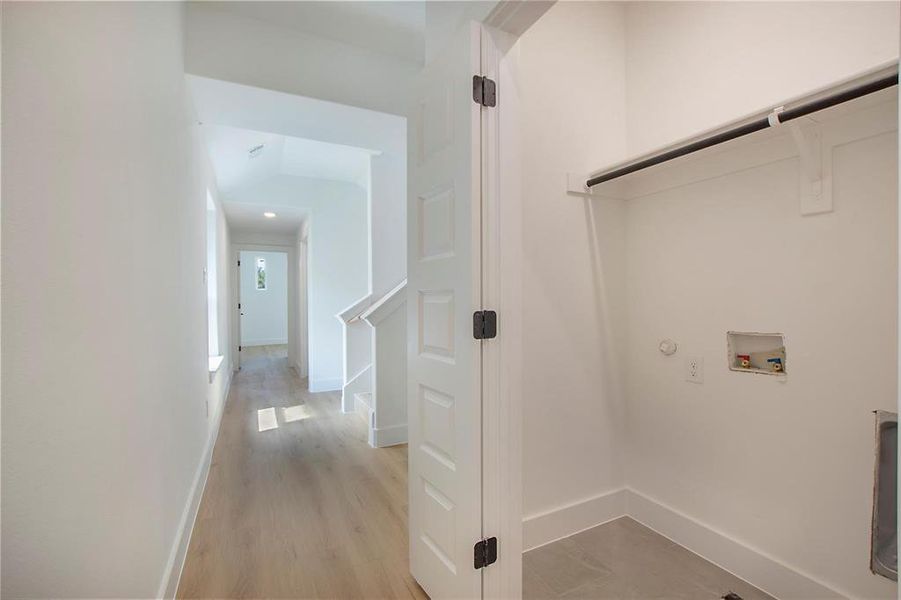 Laundry room featuring washer hookup, light hardwood / wood-style floors, and gas dryer hookup