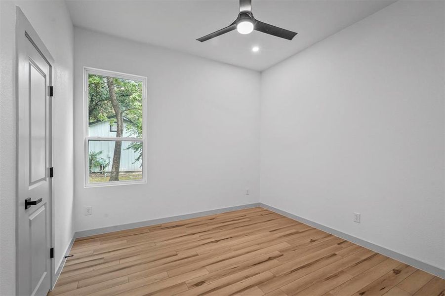 Unfurnished room featuring ceiling fan and light hardwood / wood-style floors