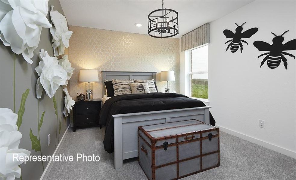 Carpeted bedroom with a notable chandelier