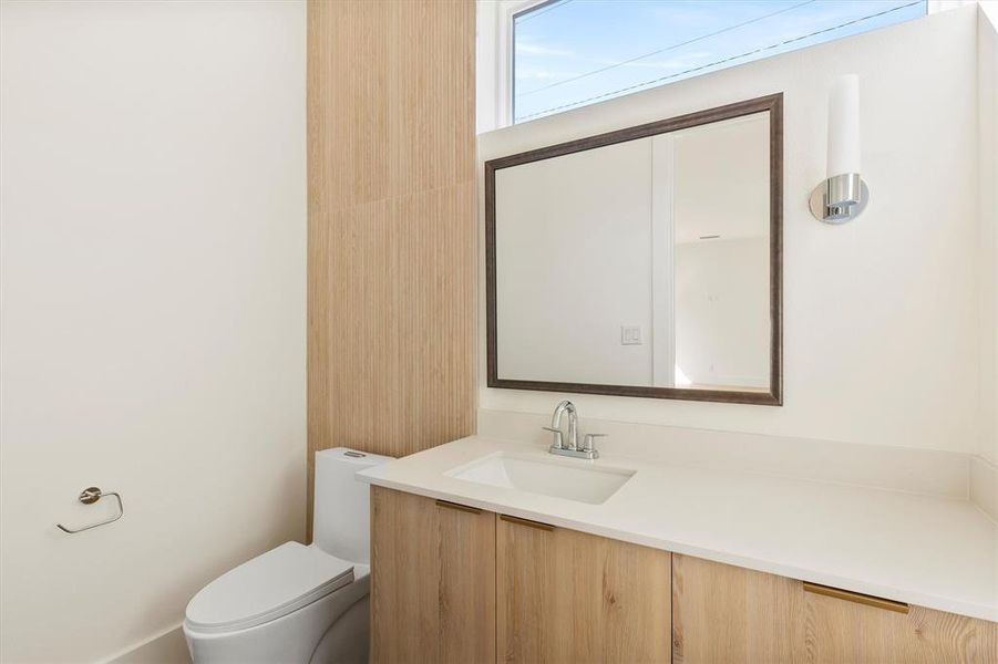 Bathroom featuring vanity and toilet