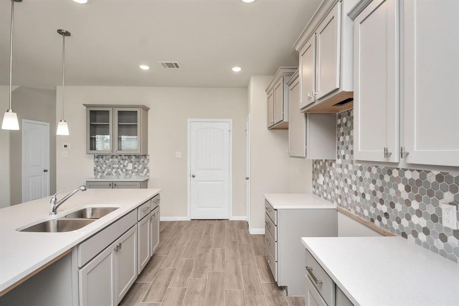 This inviting kitchen seamlessly blends function and style, making it the heart of this beautiful home. *This image is from another Saratoga Home with similar floor plan and finishes, not the Brittany floorplan.*