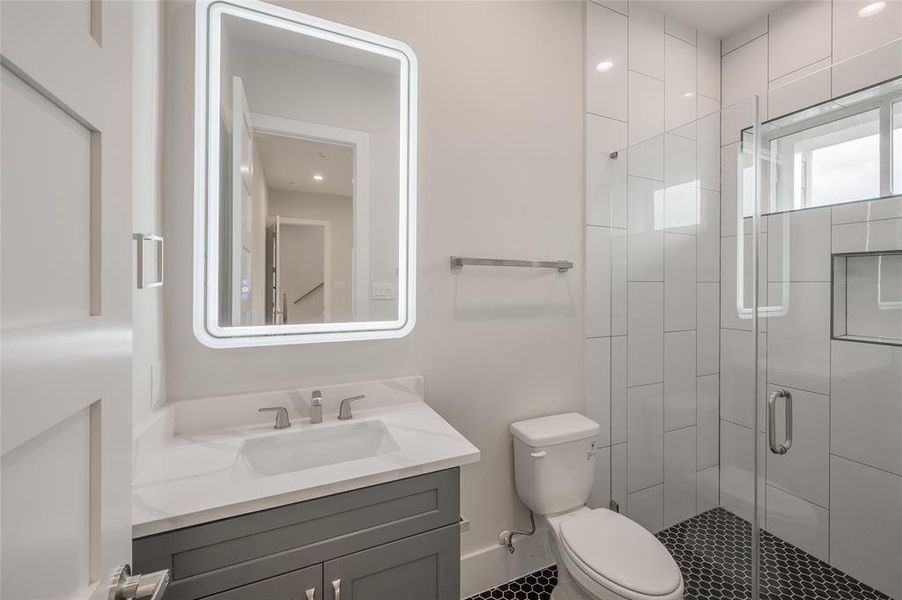 First floor bath has a large, easy access shower and quartz vanity.