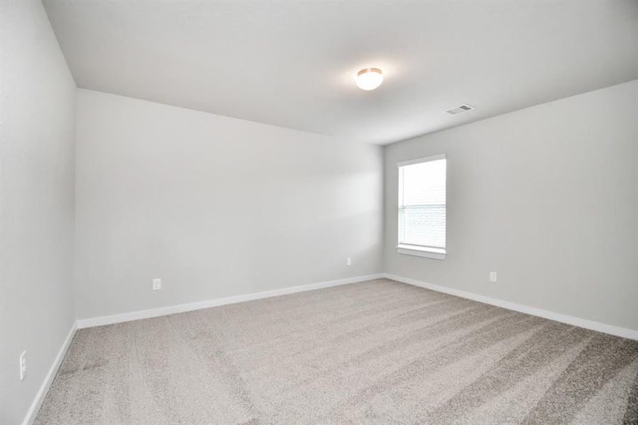 Generously sized secondary bedrooms featuring spacious closets, soft and inviting carpeting underfoot, large windows allowing plenty of natural light, and the added touch of privacy blinds for your personal retreat. Sample photo of completed home with similar floor plan. Actual colors and selections may vary.