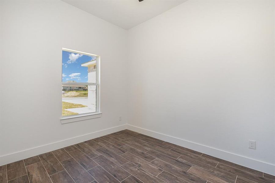 Empty room featuring dark wood-type flooring