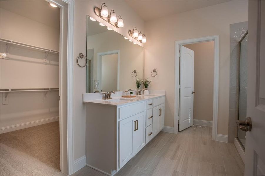 Bathroom featuring vanity and a shower with shower door