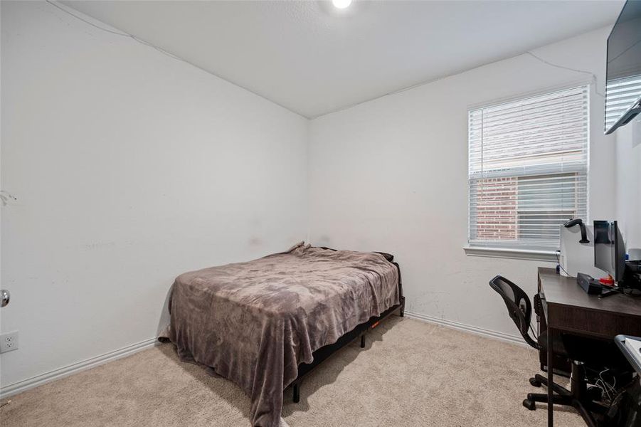 Bedroom featuring light carpet