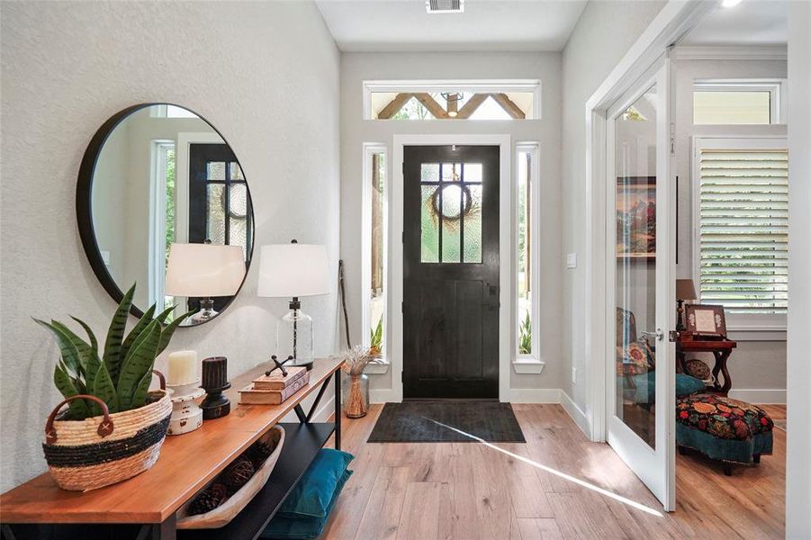 An impressive front door welcomes you in to find a fresh neutral color pallet with beautiful wood-look tile flooring and warm welcoming touches throughout.