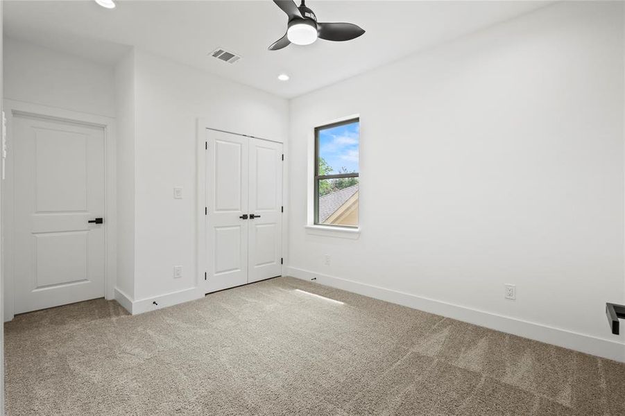 Unfurnished bedroom featuring carpet, a closet, and ceiling fan